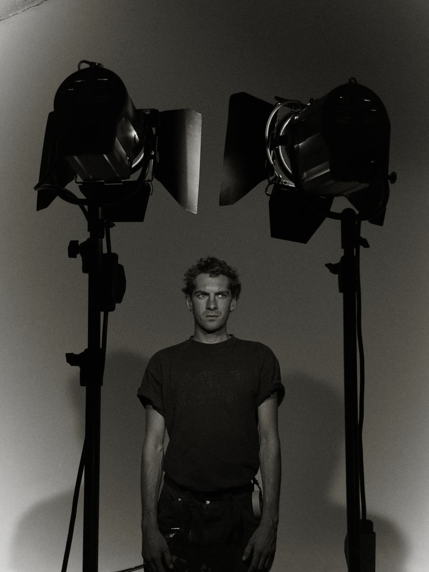 Luke Stulinski standing between two studio lights